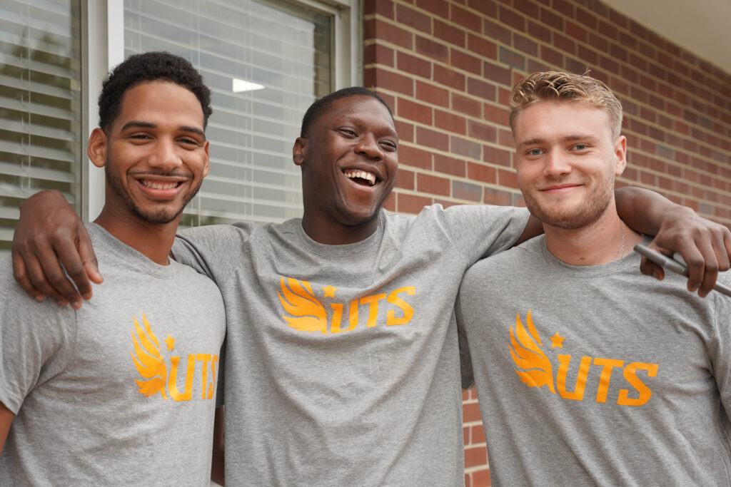 Three students smiling and laughing