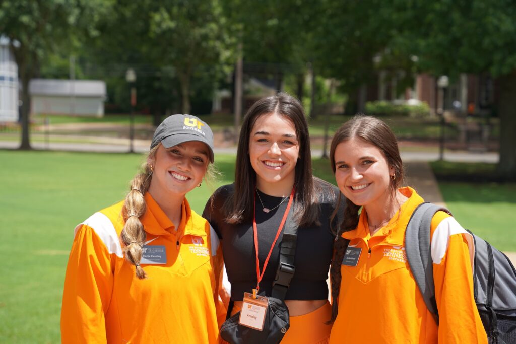 Three students in UT Southern girl, smiling at the camera