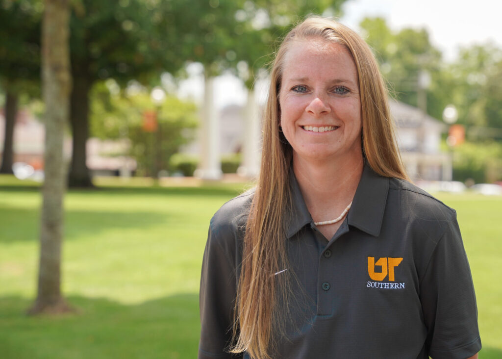 A student in UT polo shirt on campus