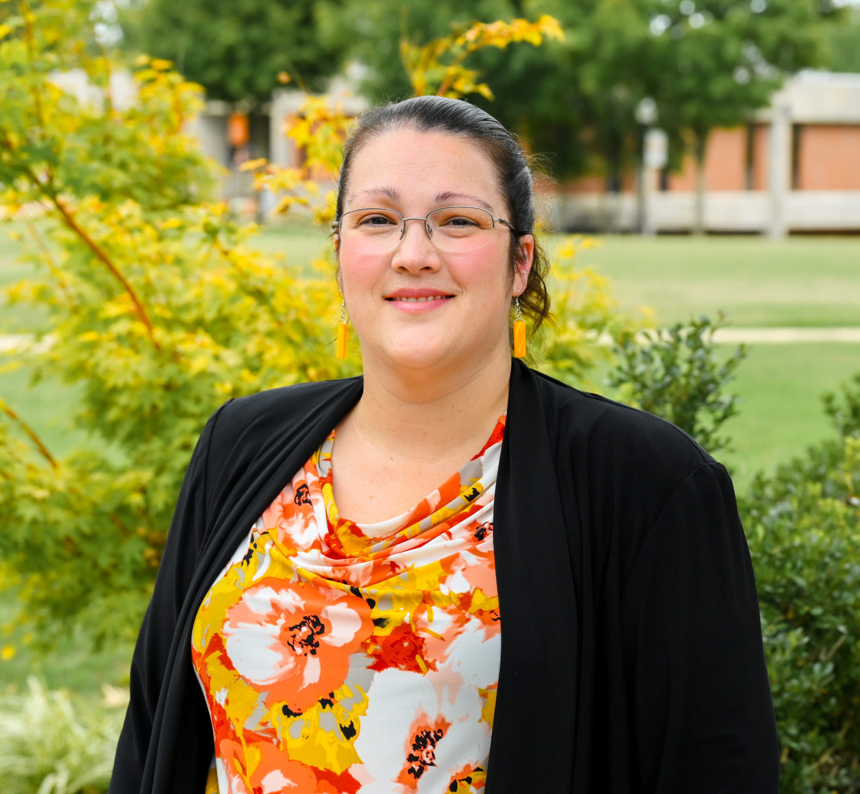 Individual headshot photo with the campus green in the distance