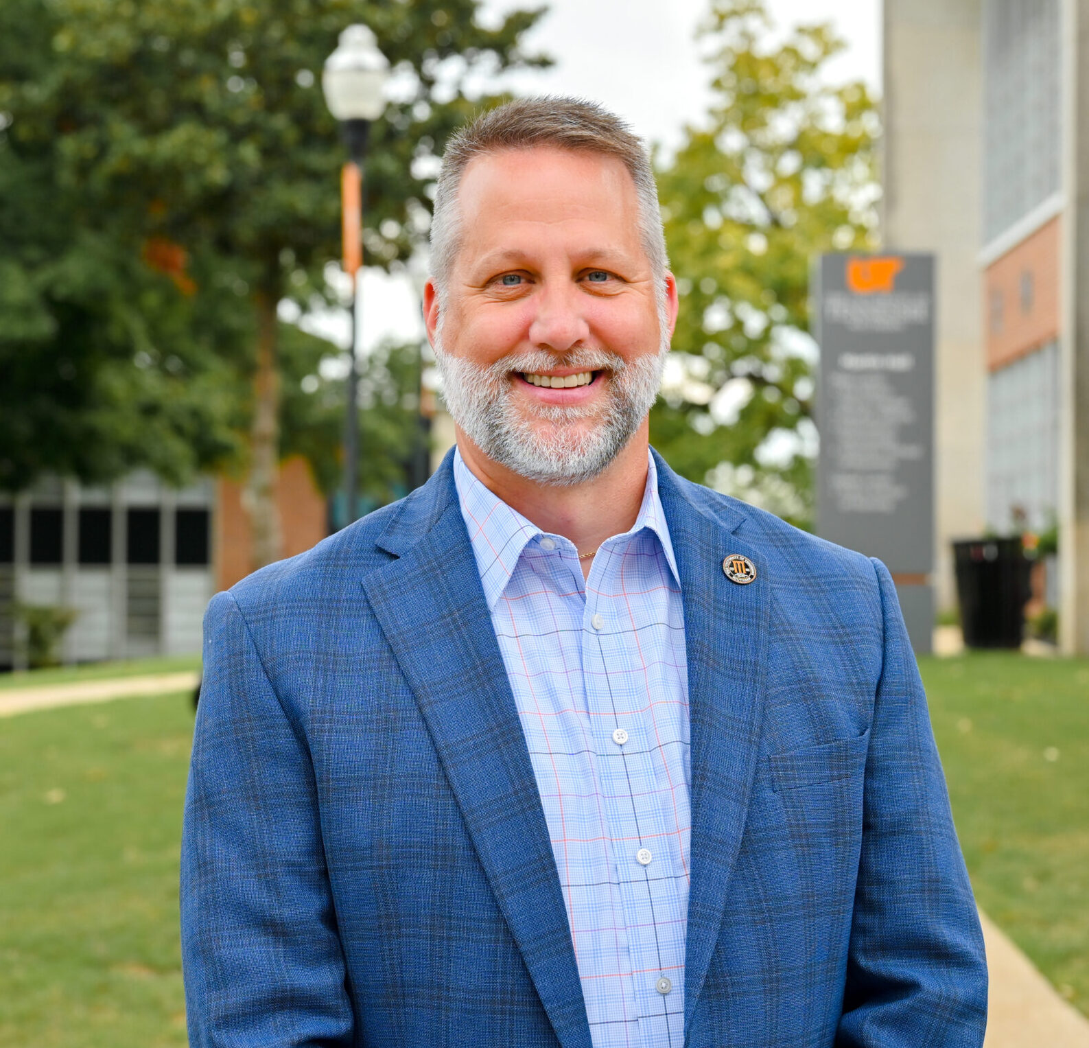 Individual headshot photo with the campus green in the distance