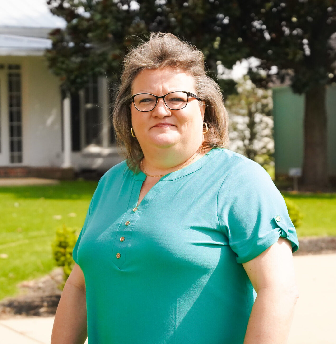 Individual headshot photo with the campus green in the distance