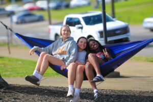 Three students on a hammock
