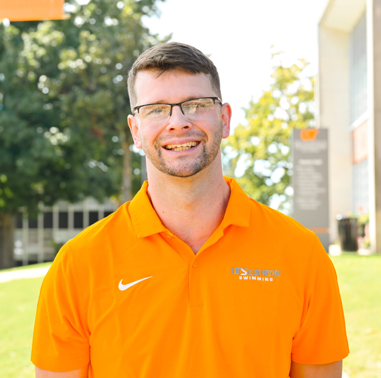 Individual headshot photo with the campus green in the distance