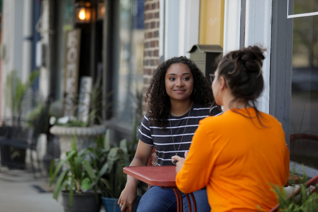 Two students chatting at a table