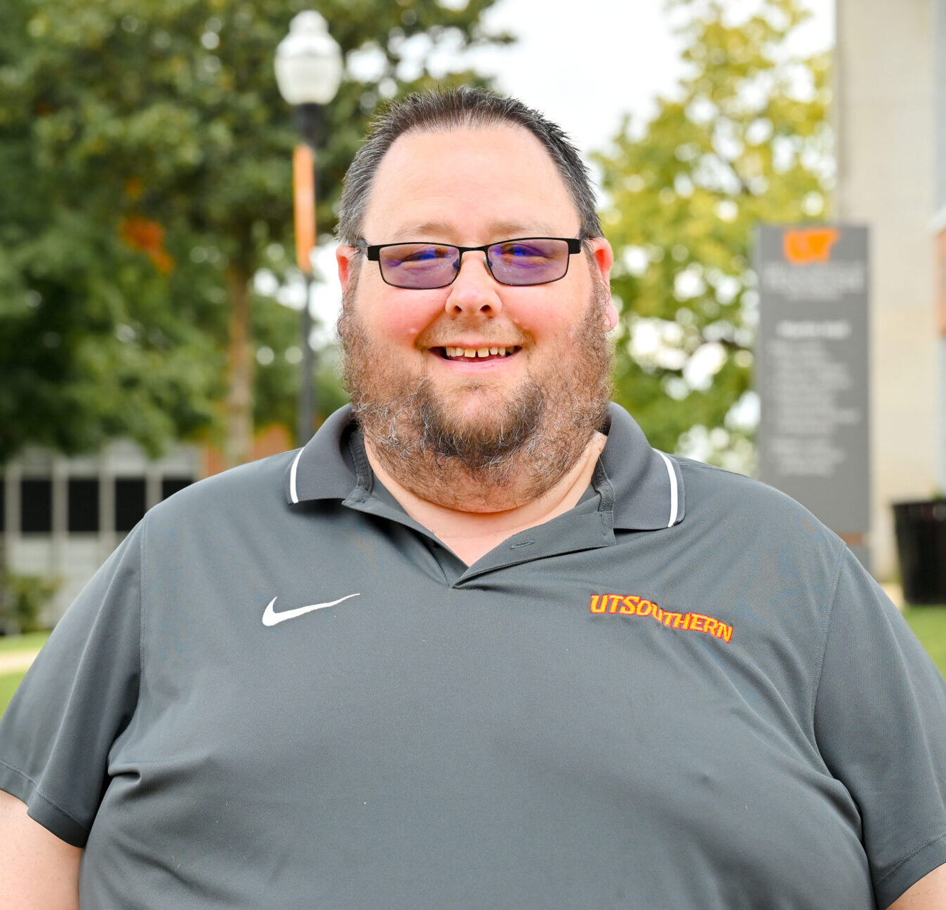 Individual headshot photo with the campus green in the distance