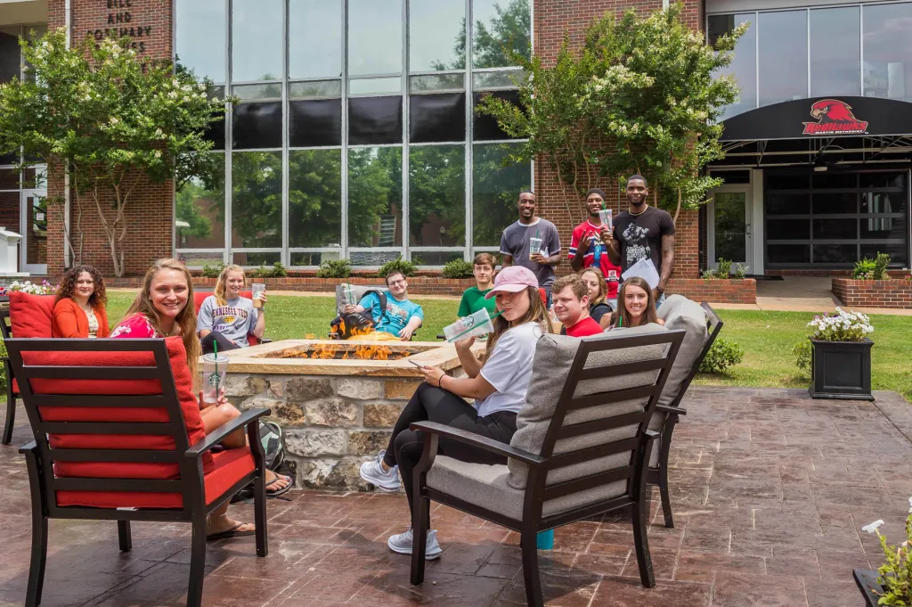 Students sitting at a table outside the cafe