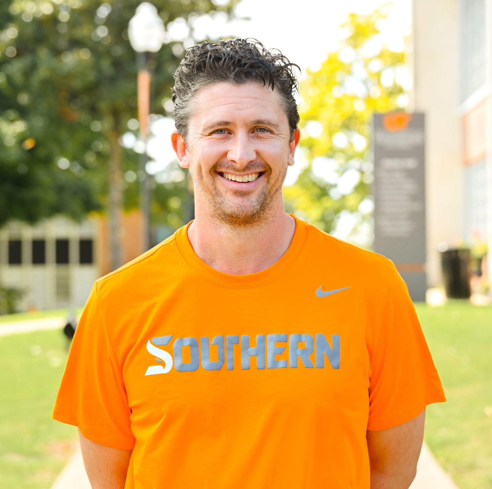 Individual headshot photo with the campus green in the distance