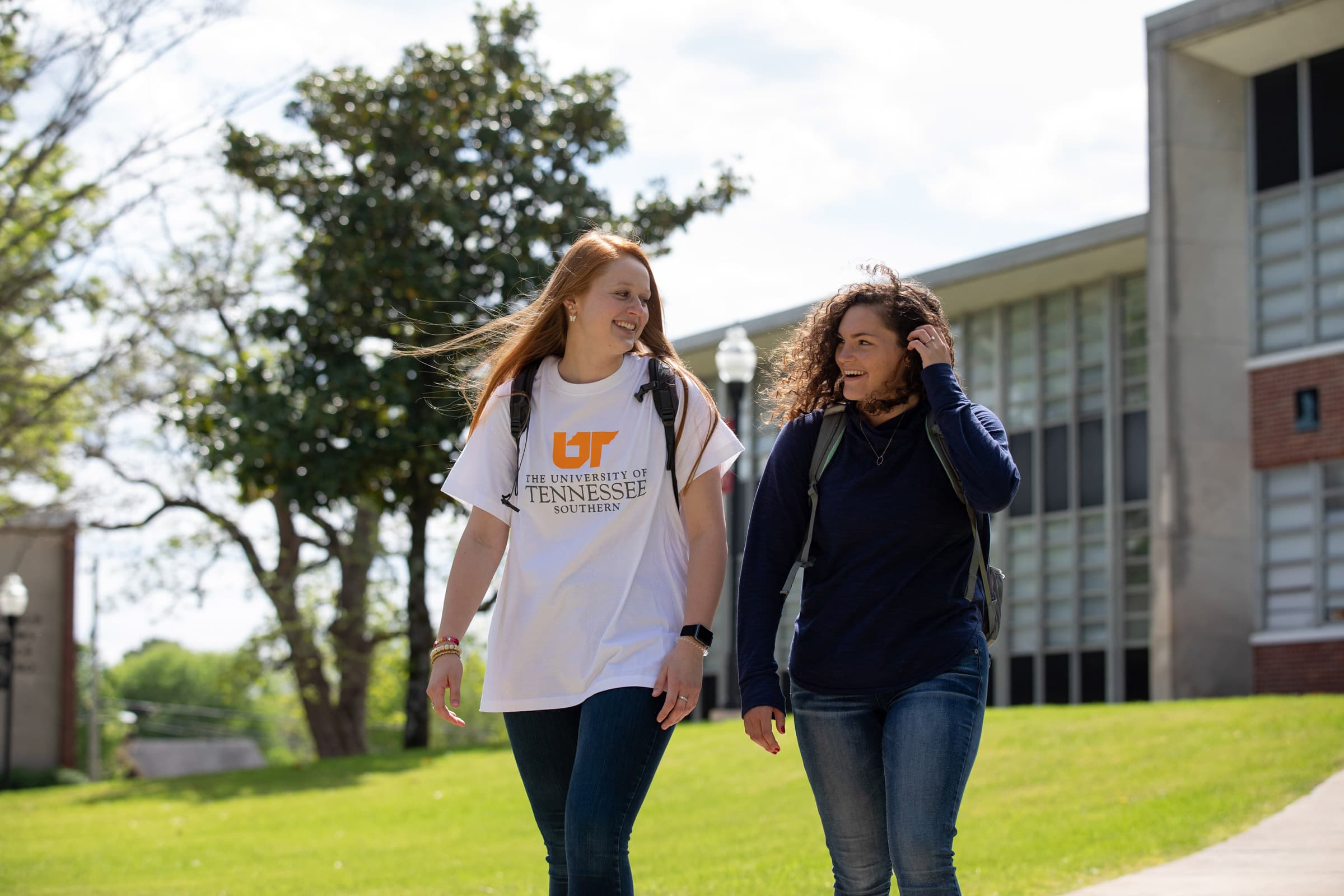 Two students walking on campus