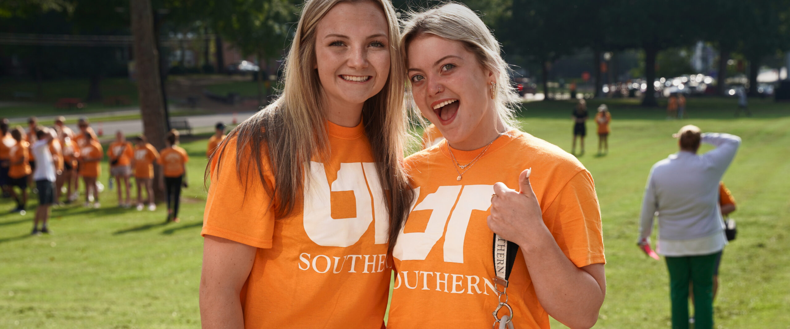 Two students in UT shirts smiling