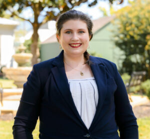 Individual headshot photo with the campus green in the distance