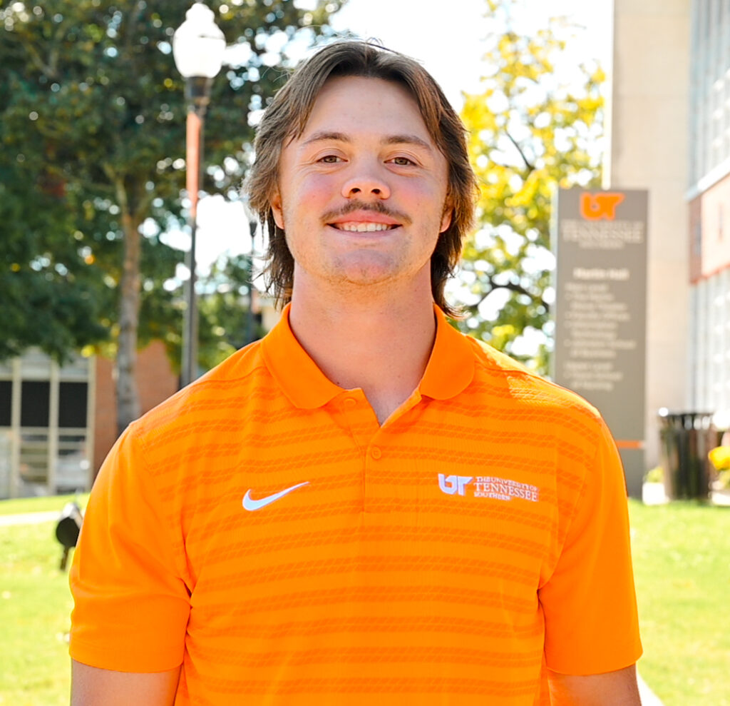 Individual headshot photo with the campus green in the distance