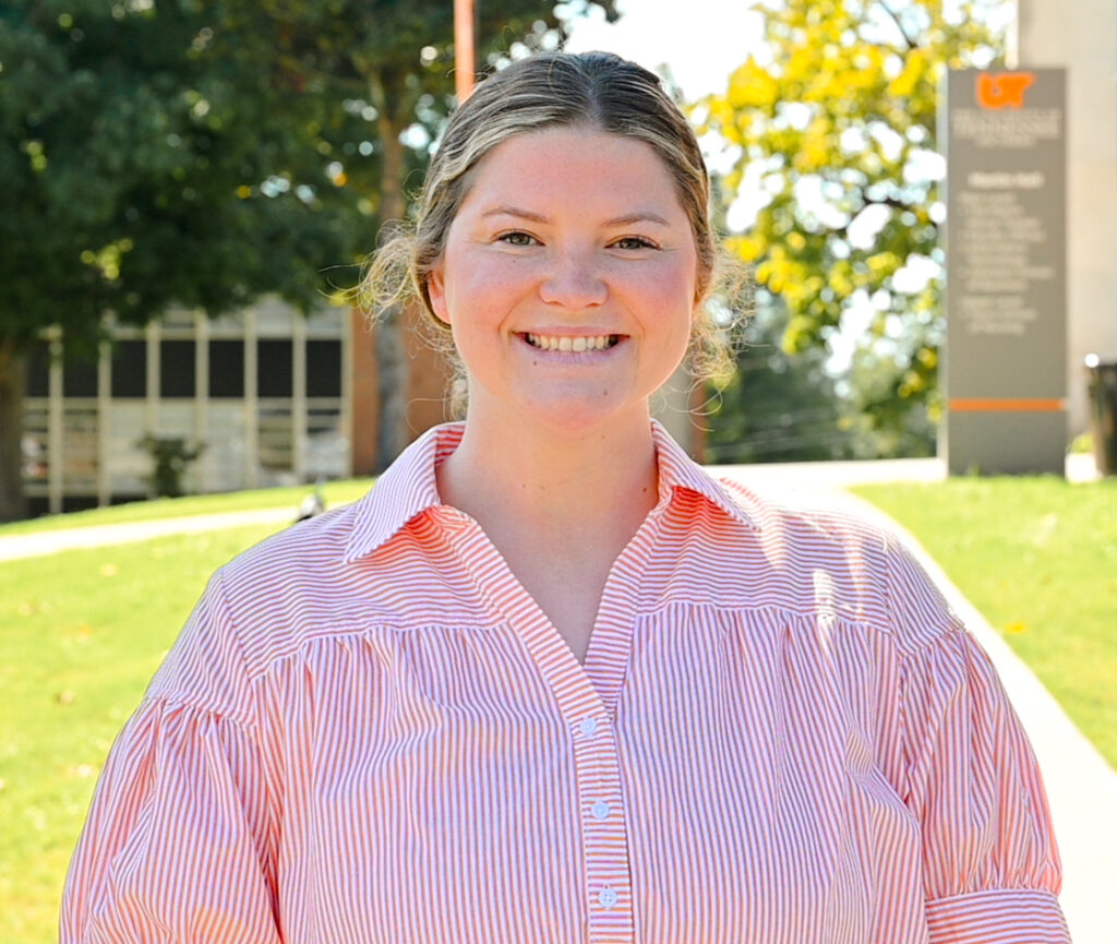 Individual headshot photo with the campus green in the distance