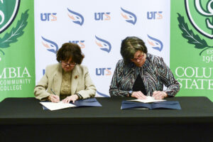 President and Chancellor at signing table ratifying agreements